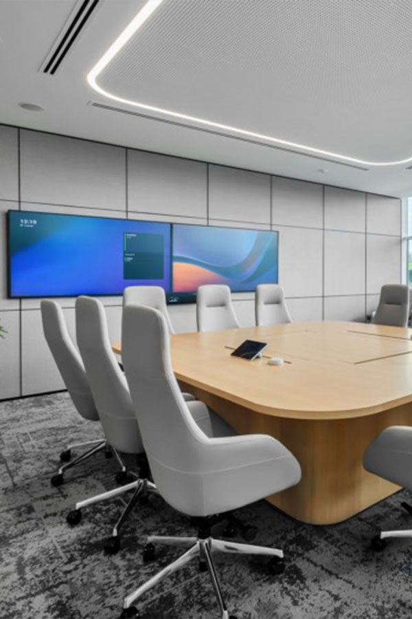 Contemporary office interior featuring an open-plan layout, sleek wooden workstations, and floor-to-ceiling glass partitions, designed for collaboration and natural light